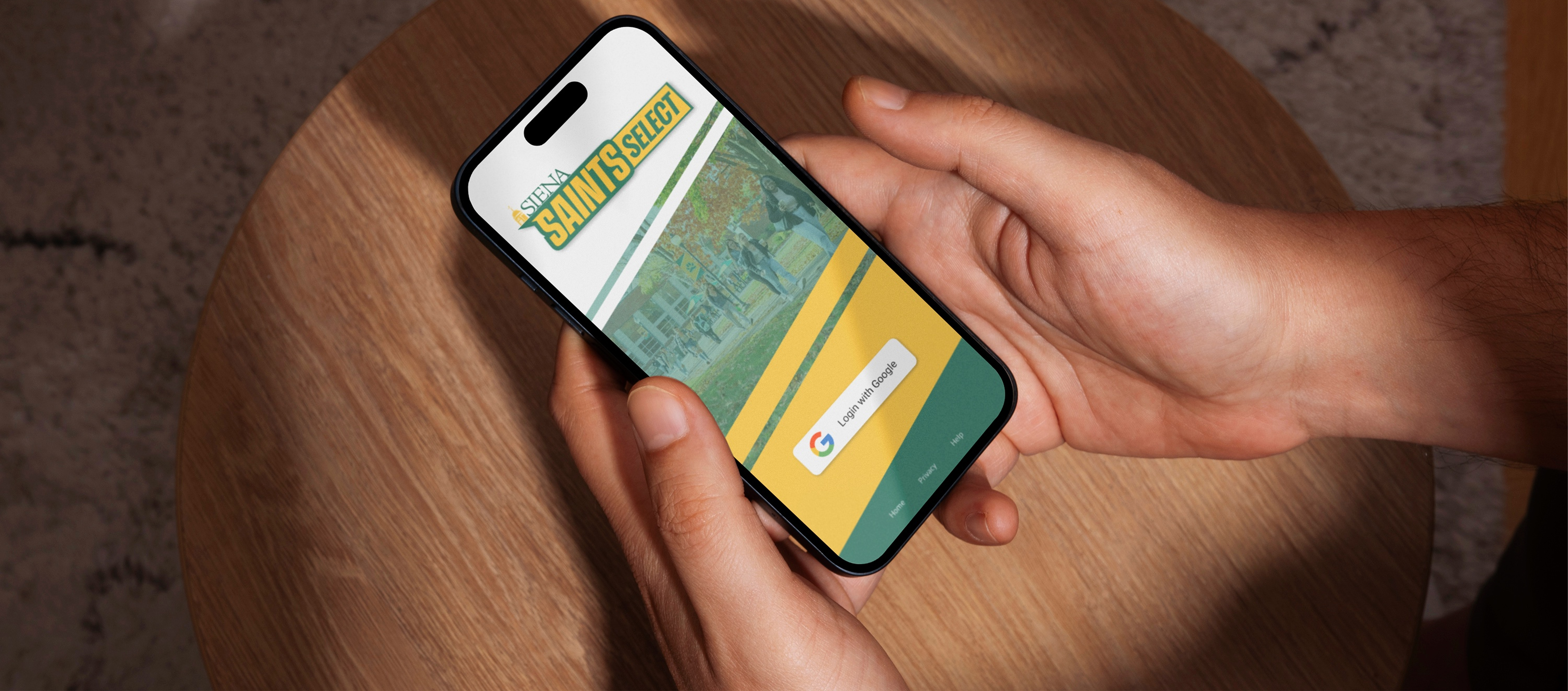 Mockup of an iPhone showing the SaintsSelect login screen.